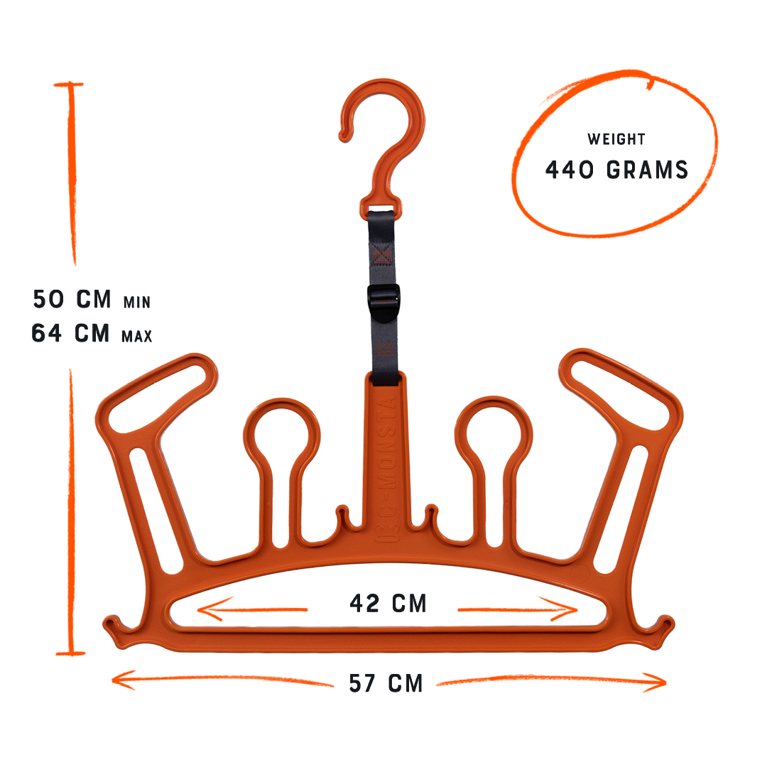 C-Monsta orange wetsuit hanger in use – full wetsuit with gloves hanging from tree on sandy beach