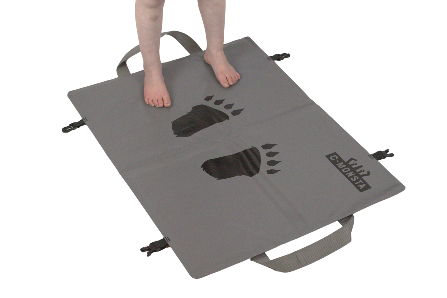 C-Monsta changing mat – person standing on mat showing textured footprint surface and carry straps